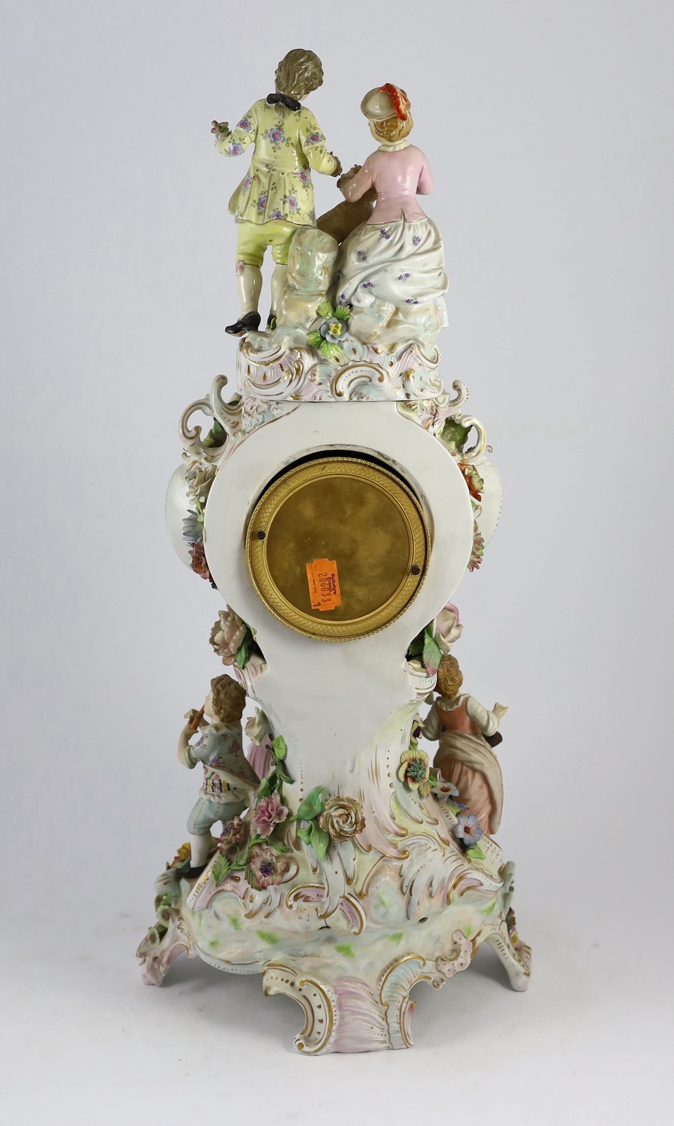 An impressive German porcelain floral encrusted figural mantel clock, late 19th century, Total height 65 cm